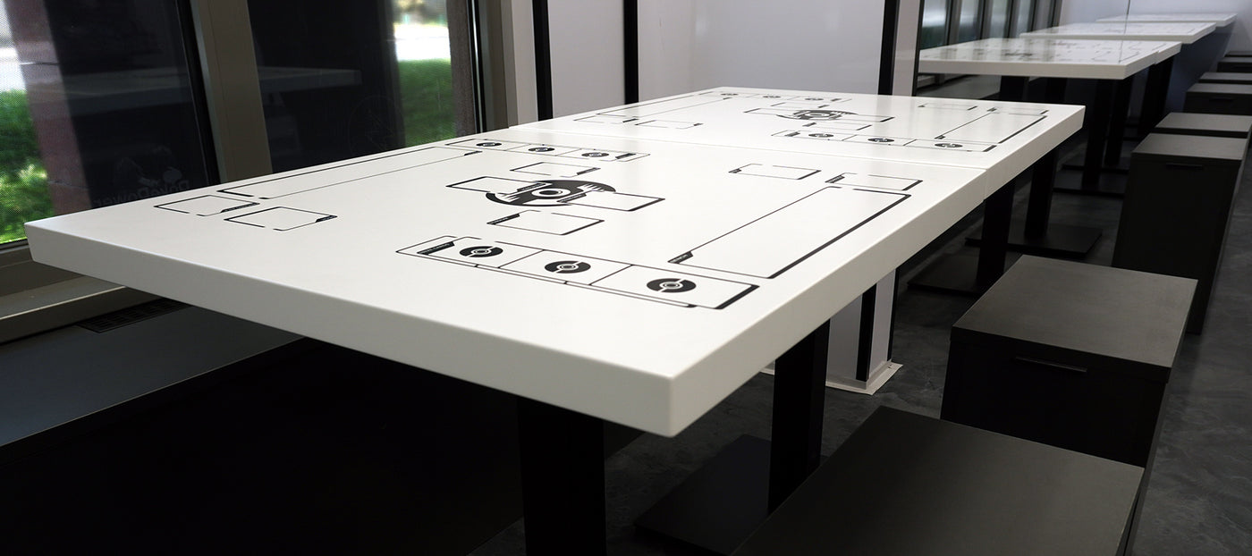 Pokémon TCG play table with printed layout in PokePower store event area.