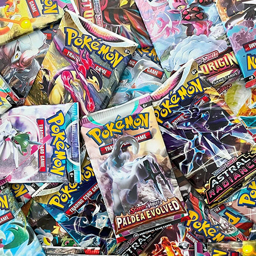 Assorted Pokémon TCG booster packs including Paldea Evolved, Astral Radiance, and Lost Origin.