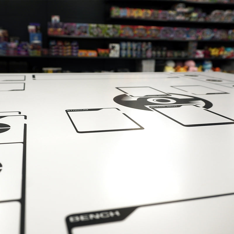 Close-up of Pokémon TCG play table with printed layout at PokePower store.